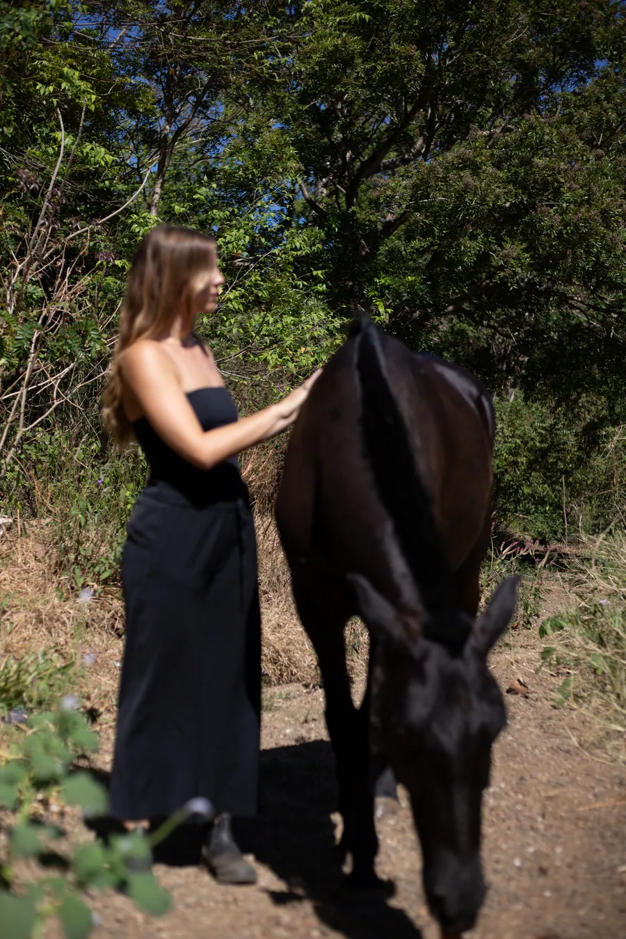 Charlotte walking with a horse on a dirt track